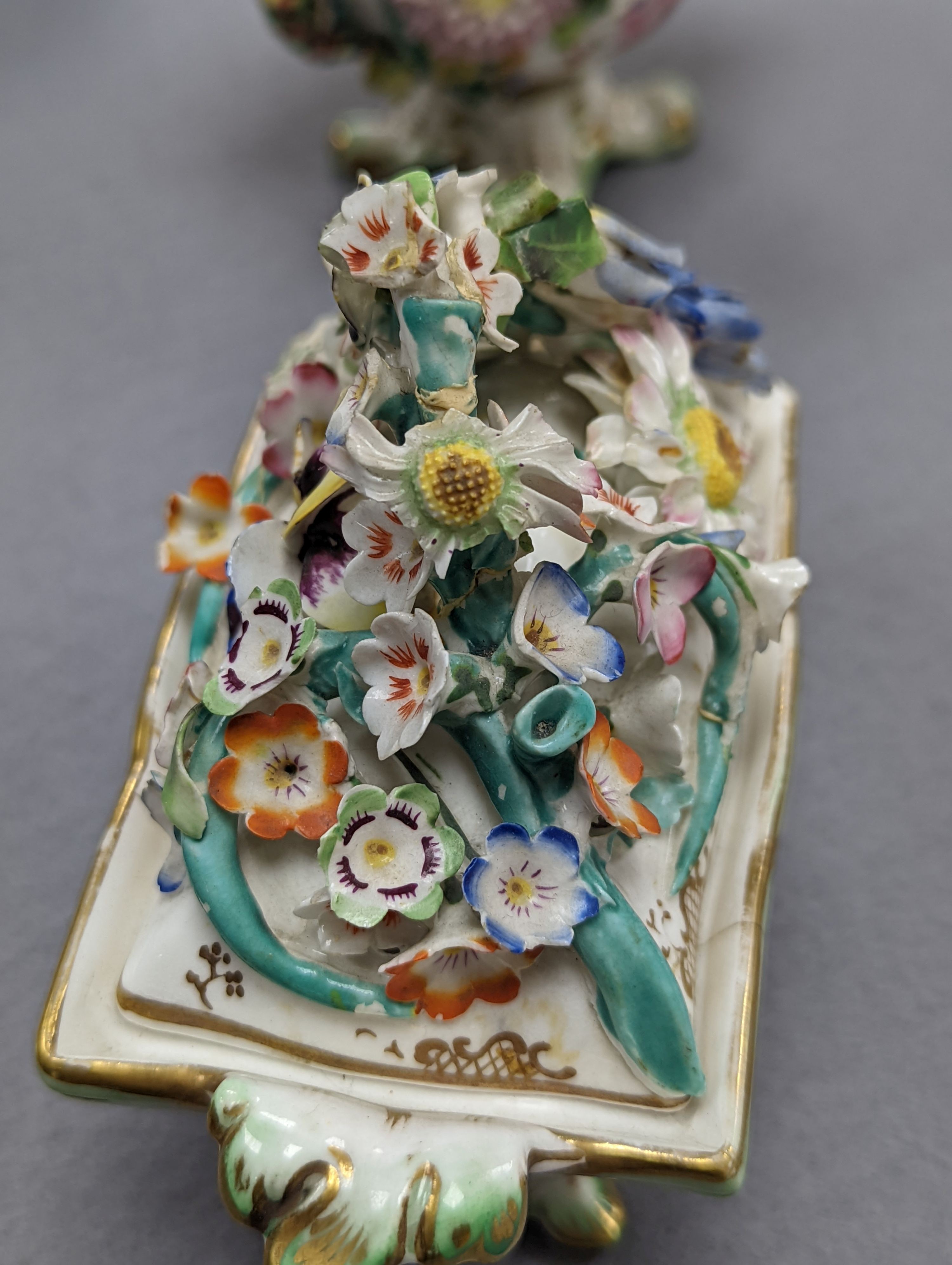 An 18th century Mennecy porcelain cup and cover, a Meissen style cup and cover, an English porcelain floral encrusted double inkwell and cover and a similar jar and cover